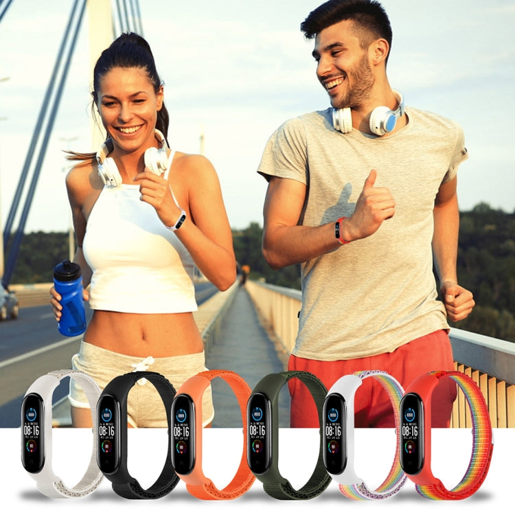 Fitness tracker and nylon loop watch bands in white, orange, green, and red rainbow