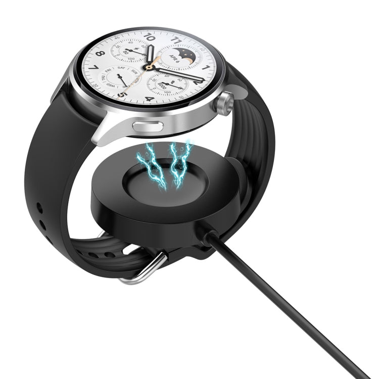 Magnetic charging cable connecting to a smartwatch; charging puck with blue light