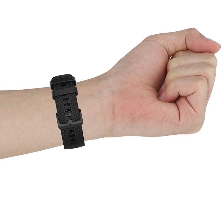 Black 22mm silicone watch strap on wrist, textured exterior and buckle in view.