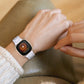 White resin watch band worn on wrist with metal clasp