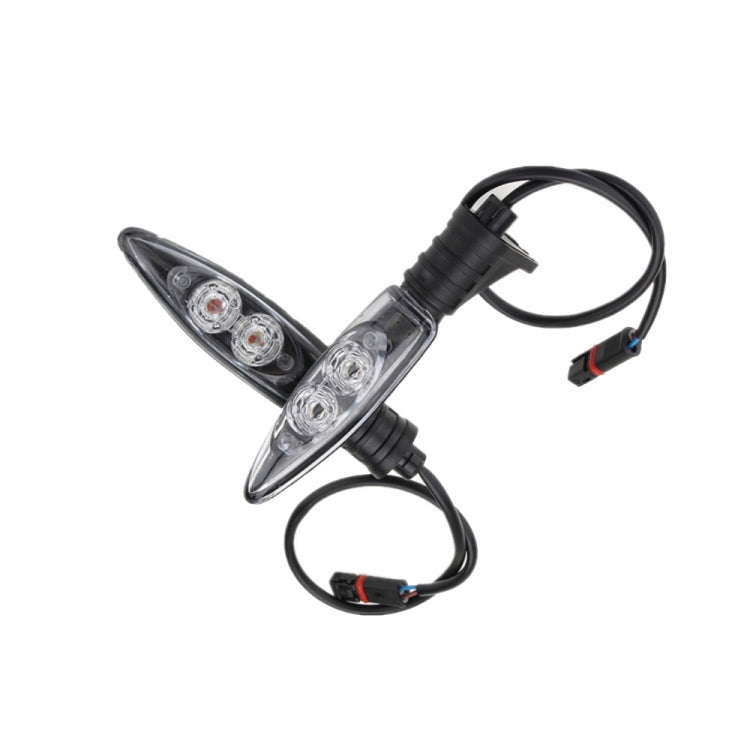 Two clear-lens LED motorcycle rear turn signals with black housings and wiring