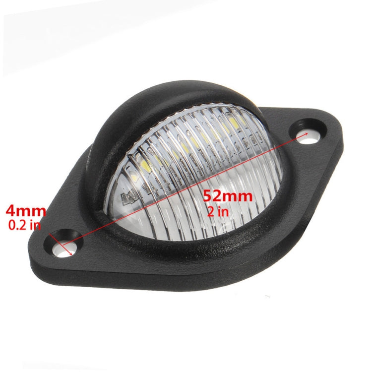 Close-up of round 3-LED license plate light lens, black housing, 52mm size
