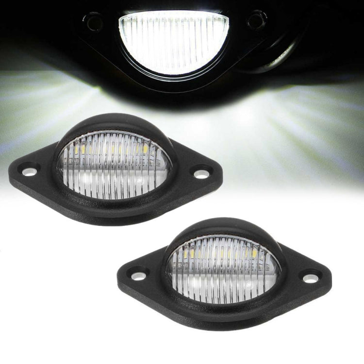 Round license plate light set with black housings; one lens illuminated, mounting holes