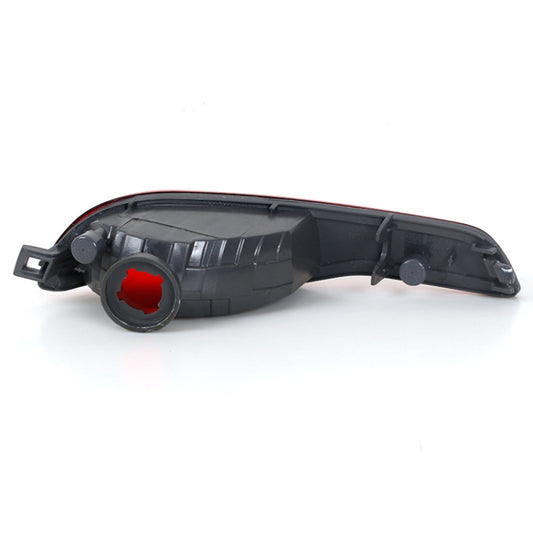 Rear bumper fog lamp housing with red lens insert and mounting tabs