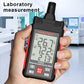 Handheld temperature humidity meter held in hand with LCD temperature and RH values