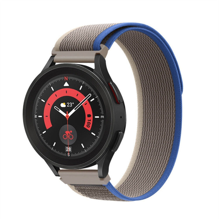 Beige and blue nylon loop watch band with textured weave and metal clasp, shown on watch