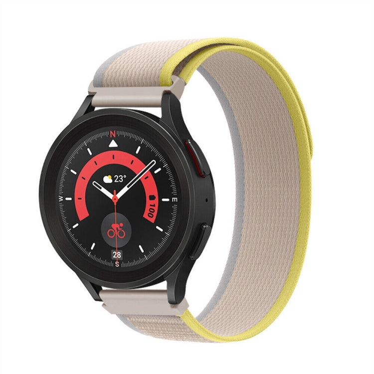 Beige nylon loop watch band with yellow trim, textured weave and metal clasp, shown on watch