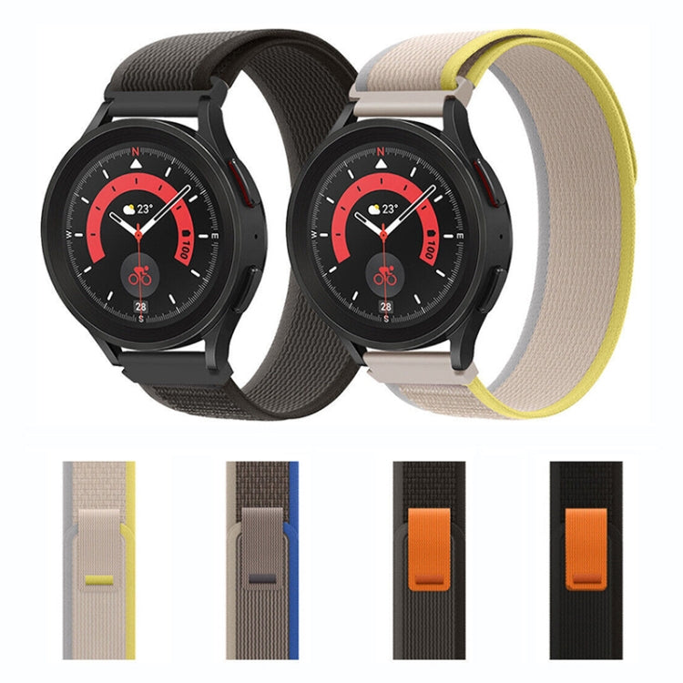 Pair of nylon loop watch bands: black and beige with yellow accents, shown on watches