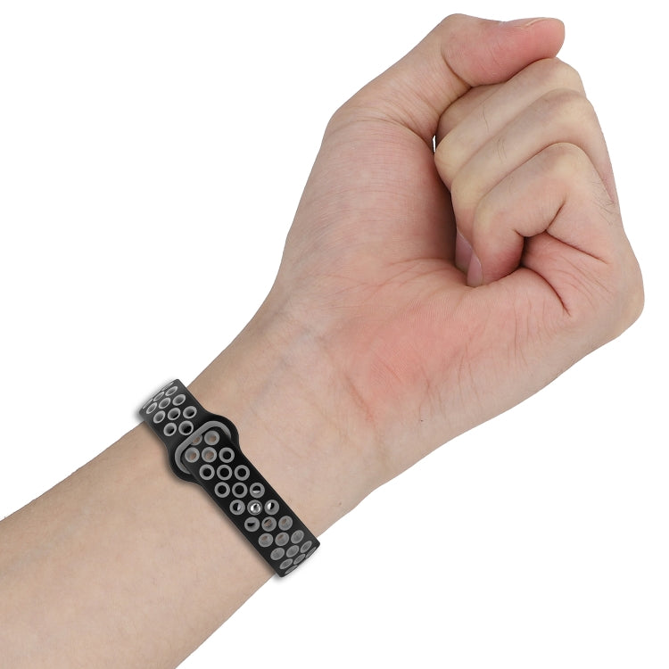 Two-color silicone watch band with reverse buckle on wrist, black strap with perforated light underside