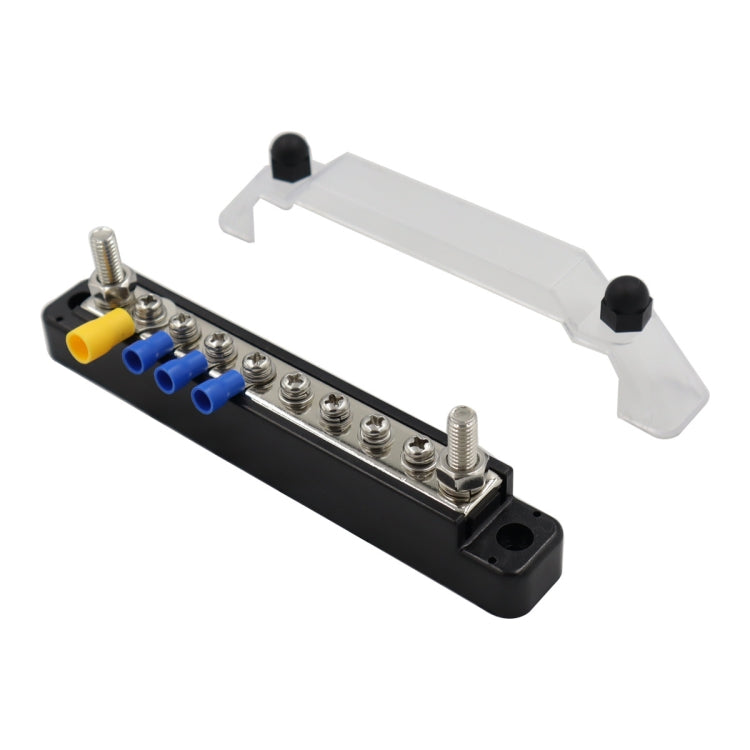 Black terminal block with stud posts and yellow/blue ring connectors, plus clear cover
