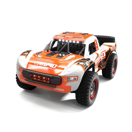 Brushless RC pickup truck front-left view, orange-and-white body, LED light details