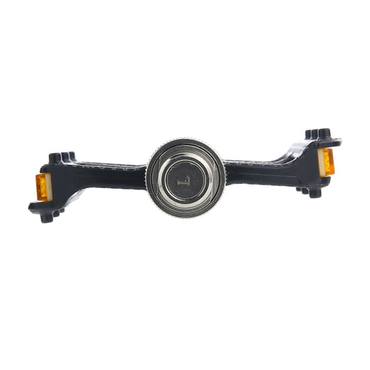 Bicycle quick-release pedal with black carbon fiber body, central silver axle, amber reflectors