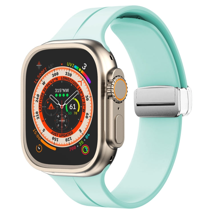 Light teal silicone watch band with magnetic fold clasp for Apple Watch, side view.