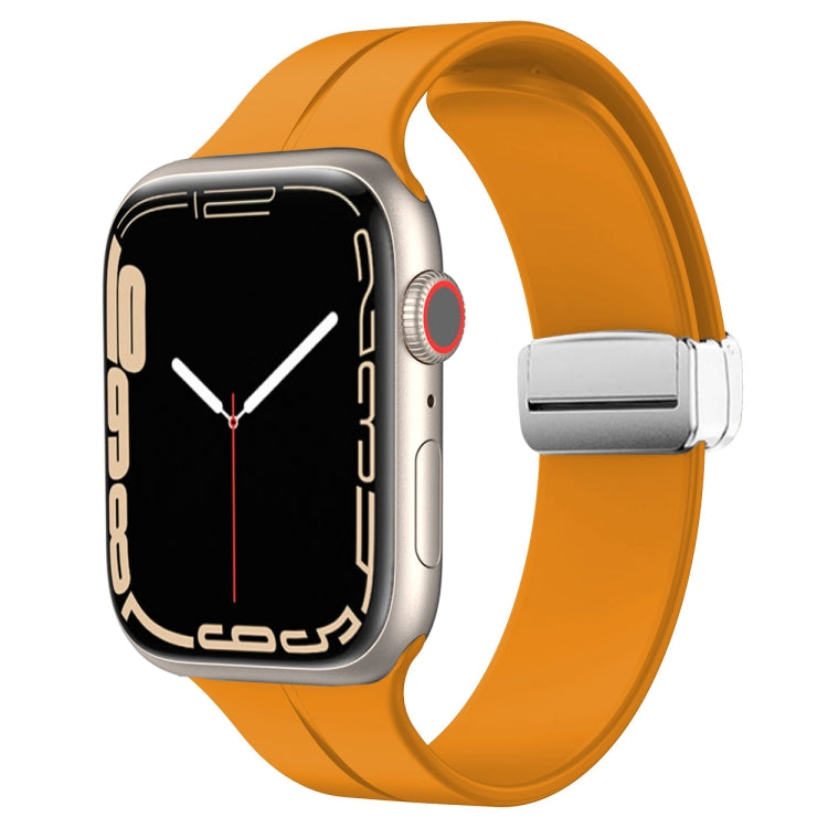 Orange silicone watch band with magnetic fold clasp for Apple Watch, side view.
