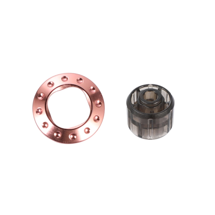 Rose pink metal cap ring with five studs and included removal tool