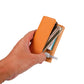 Orange portable electronic cigarette case held in hand with inner compartment visible