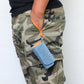 Blue denim portable electronic cigarette case worn with wrist strap on camo pants