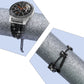 Black rhinestone watch strap with metal end caps, chain, and clover charm