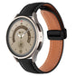 Black genuine leather watch band with folding buckle, brown underside and stitched trim.