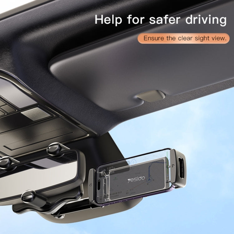 Car rearview mirror phone holder holding a phone in the center cradle