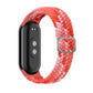 Adjustable braided elastic watch band in coral and pink with adjustable metal clasp