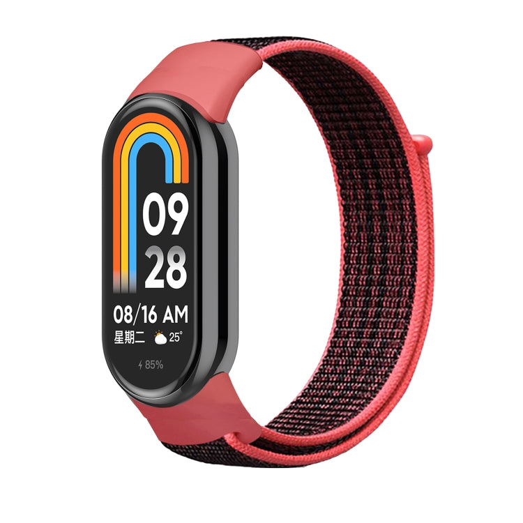Red nylon loop watch band with dark clasp, secured to a smartwatch frame.
