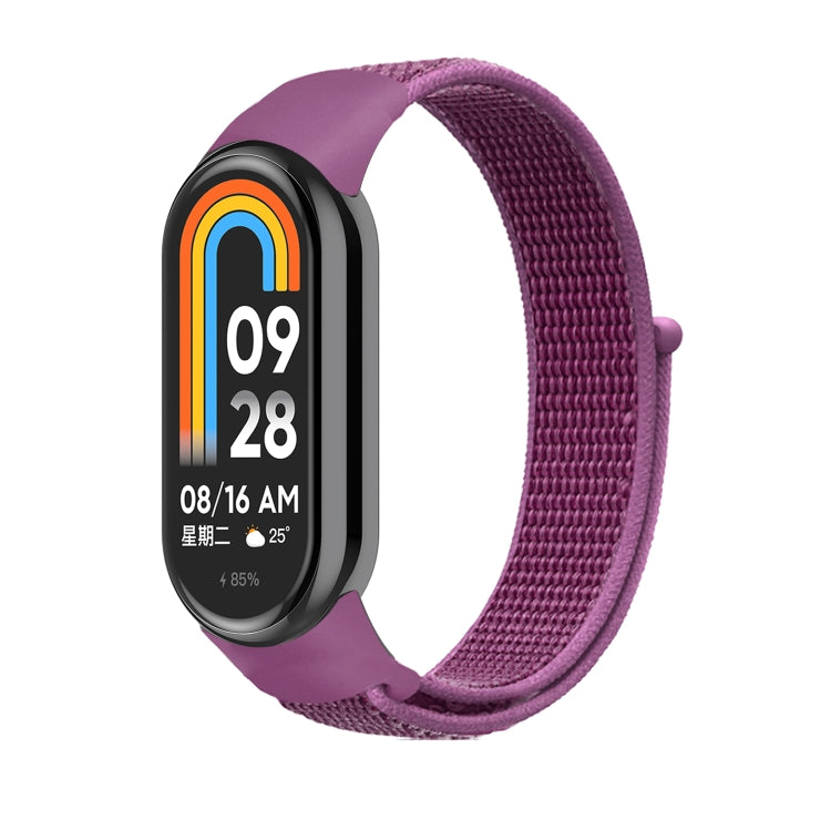 Purple nylon loop watch band with small clasp, fitted to a smartwatch frame.