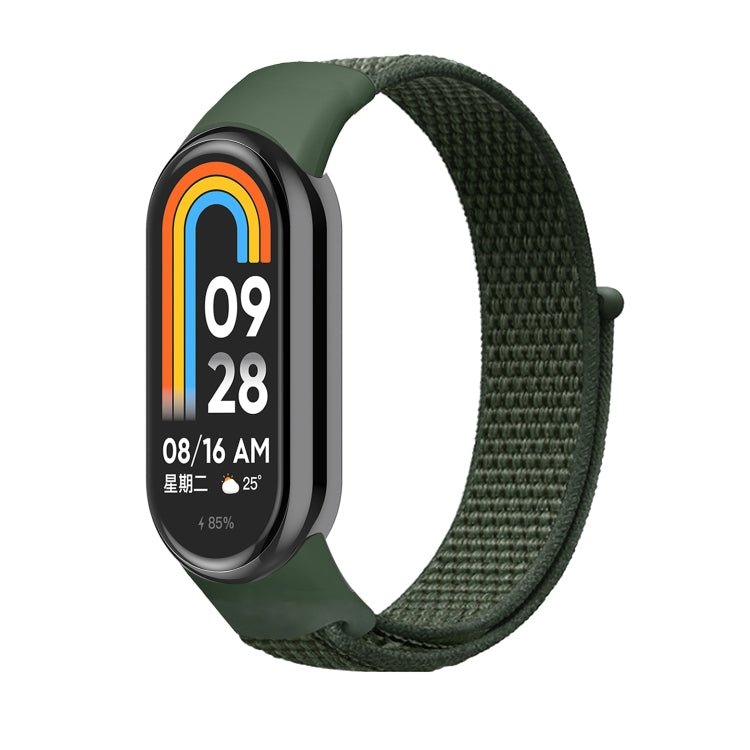 Olive green nylon loop watch band with small clasp, attached to a smartwatch.