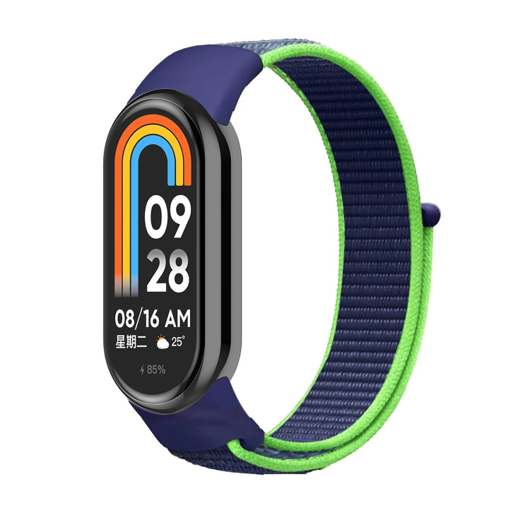 Navy and neon green nylon loop watch band with small clasp, attached to smartwatch.