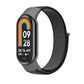 Charcoal gray nylon loop watch band with small clasp, fitted to a smartwatch frame.