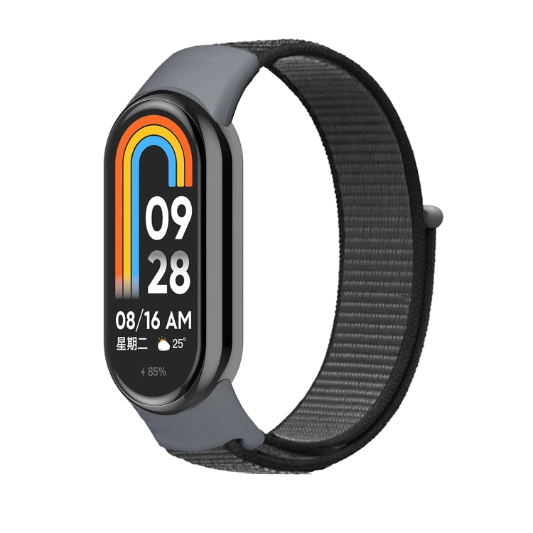 Charcoal gray nylon loop watch band with small clasp, fitted to a smartwatch frame.