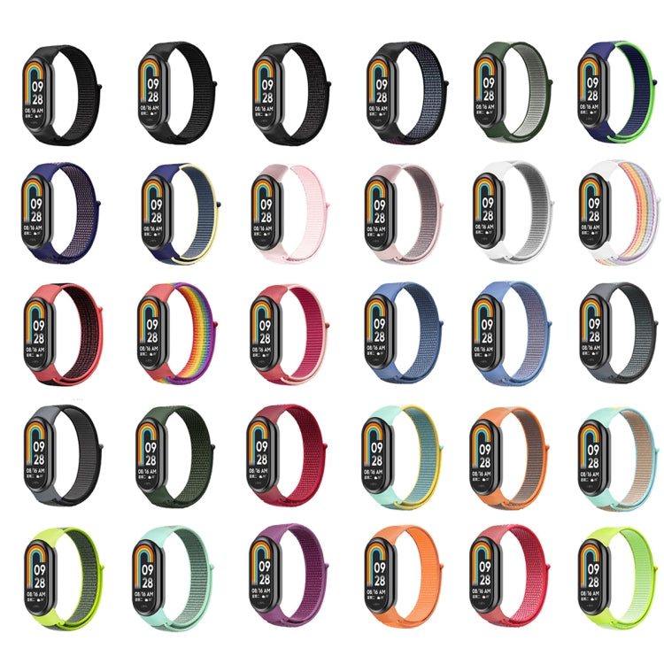 Assorted loop nylon watch bands in many colors with black smartwatch displays