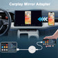 Car dashboard setup with a white CarPlay mirror adapter puck connected to phones