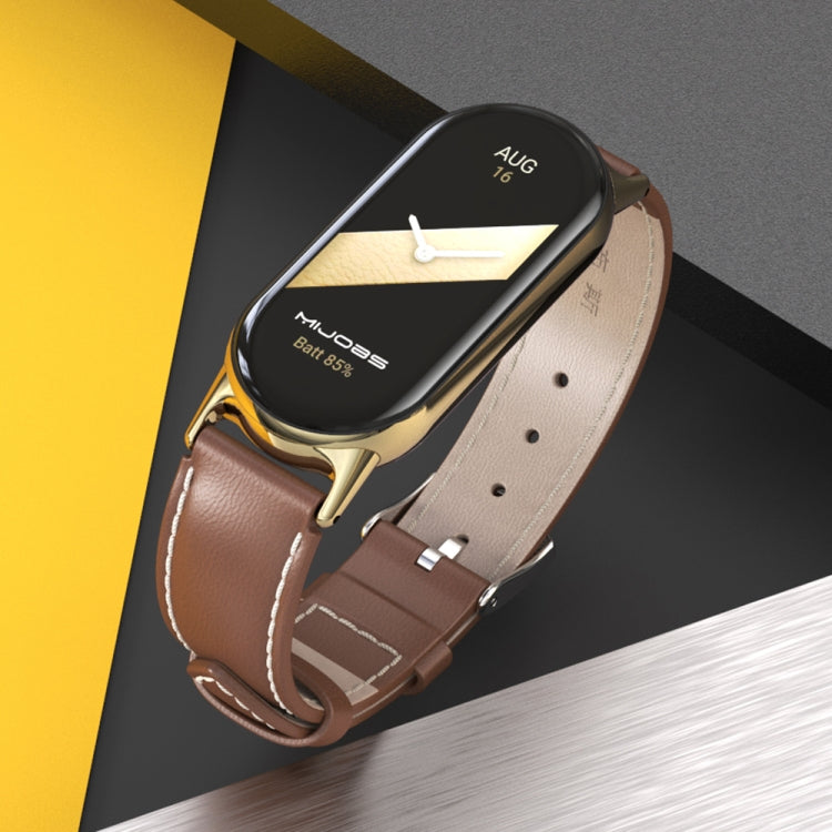 Brown genuine leather smartwatch band with gold-tone clasp, close-up