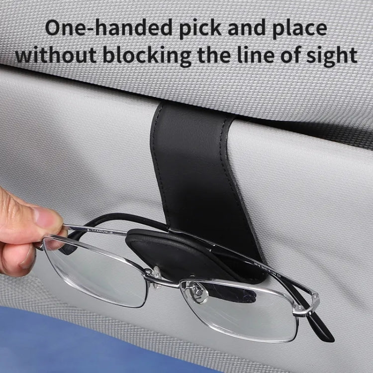Black car visor glasses holder with padded pocket holding eyeglasses near visor
