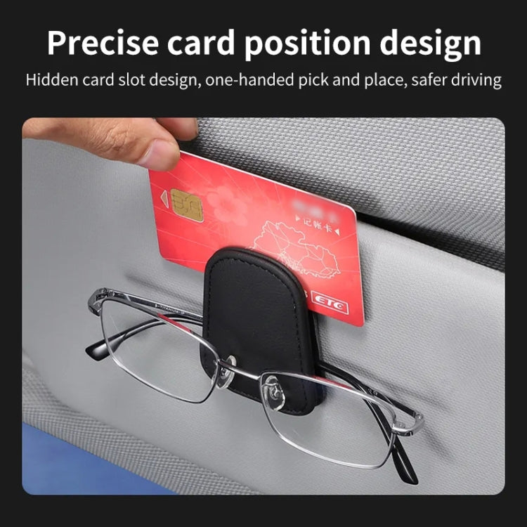Black car visor glasses holder with card slot and eyeglasses secured on dashboard