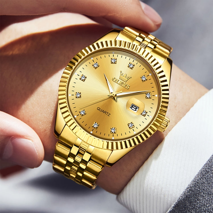 Gold-tone quartz watch close-up on wrist with diamond hour markers and date window