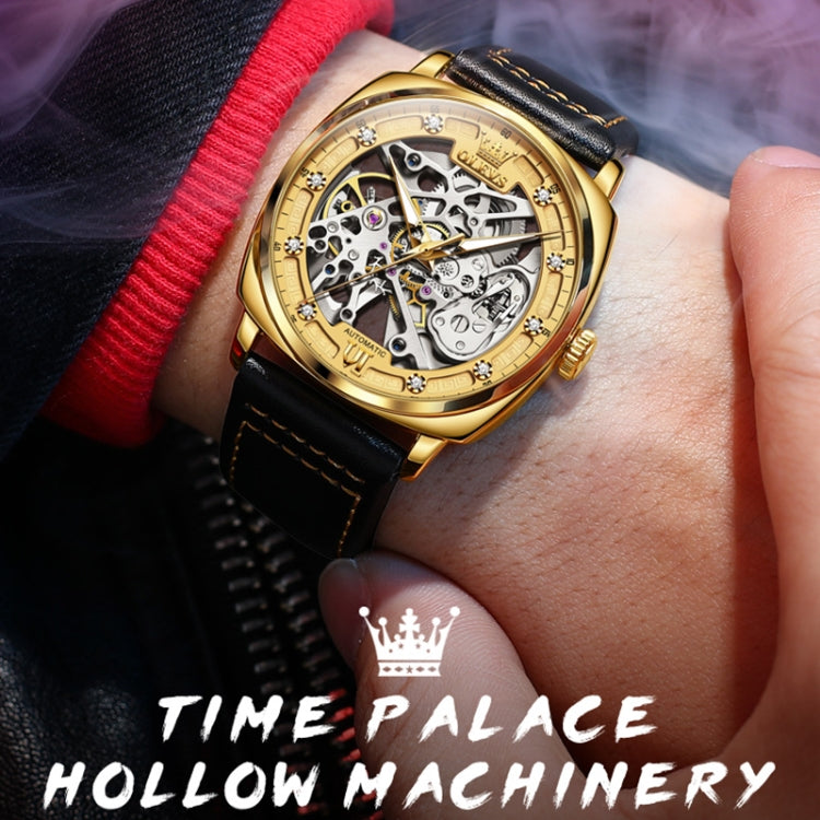 Men's hollow mechanical watch on wrist with black leather strap and gold skeleton dial