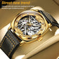 Men's gold hollow mechanical watch with black leather strap and skeleton dial close-up