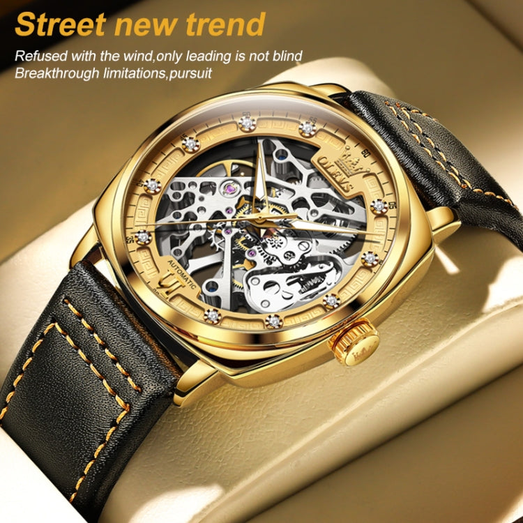 Men's gold hollow mechanical watch with black leather strap and skeleton dial close-up