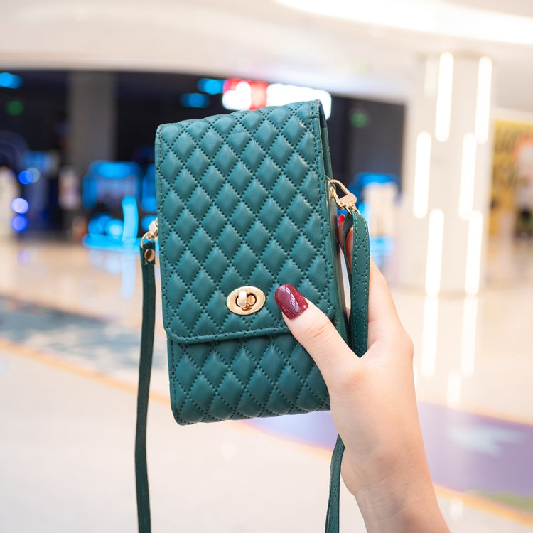 Teal quilted PU crossbody phone wallet with front flap and gold-tone clasp, held in hand