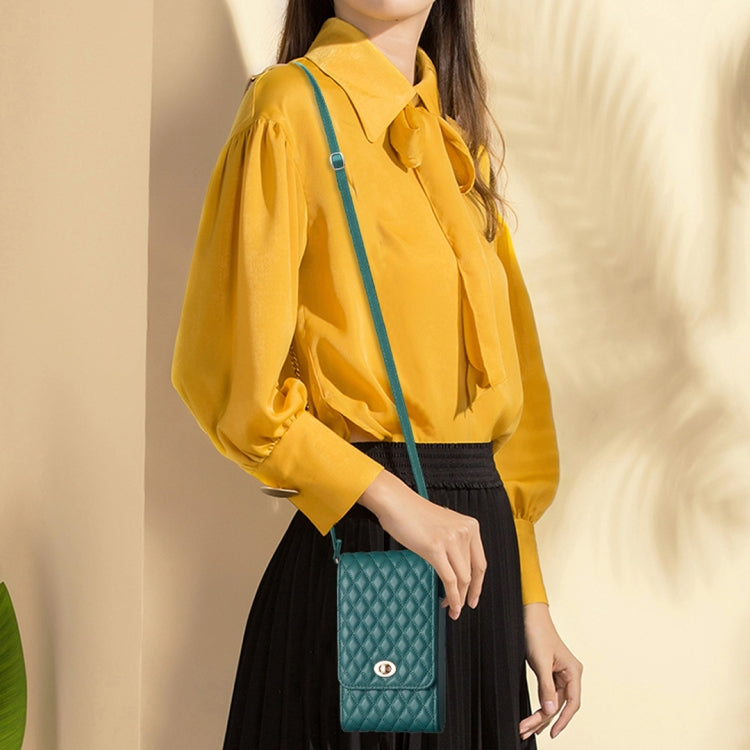 Teal quilted PU crossbody phone wallet worn with adjustable strap and front flap clasp