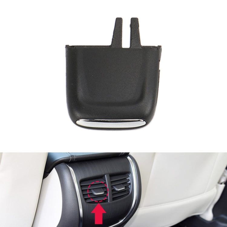 Black air outlet paddle insert with two prongs installed at rear seat vent