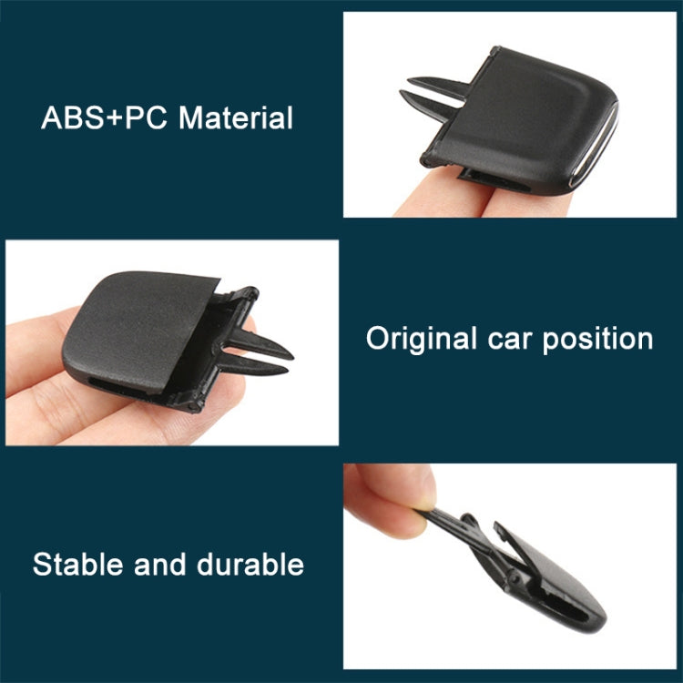 Black car air vent paddle insert with two prongs, held in hand