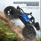 Blue and black RC climbing truck angled on a rocky slope with deep tread tires
