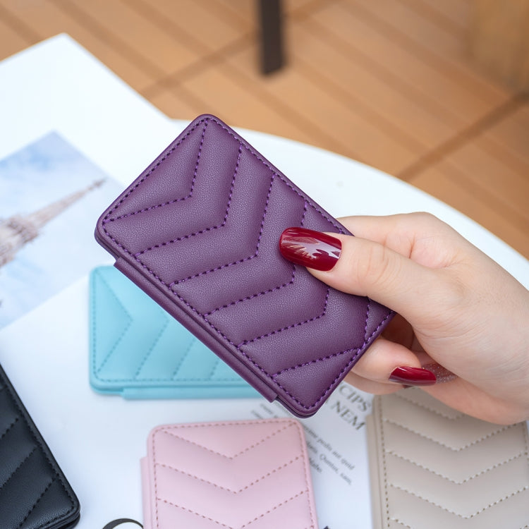 Purple wave-pattern phone card holder with chevron stitching, held in hand.