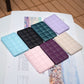 Grid-pattern mobile phone card holder stickers in multiple colors, flat lay