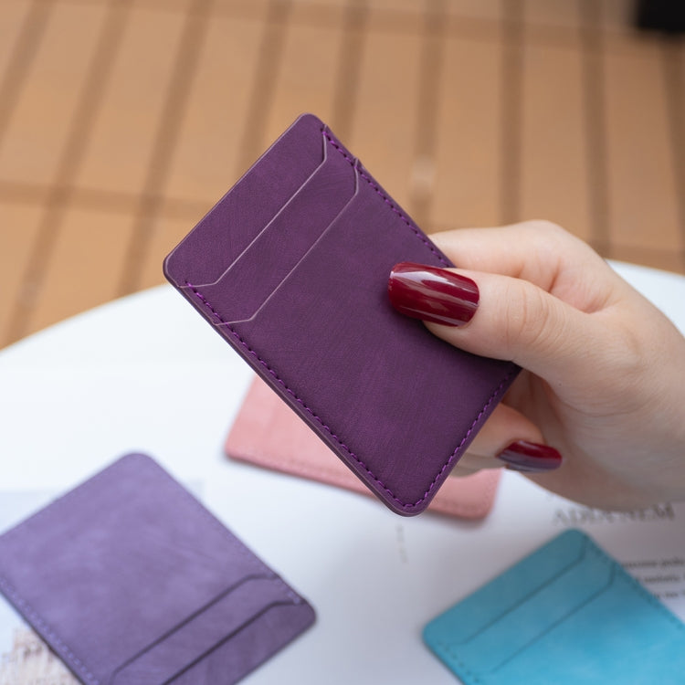 Purple phone card holder with top flap, shown held in hand
