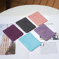 Assorted phone card holders in dark purple, black, light pink, lavender, and light blue