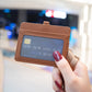 Brown horizontal ID card holder with clear window, worn on a lanyard